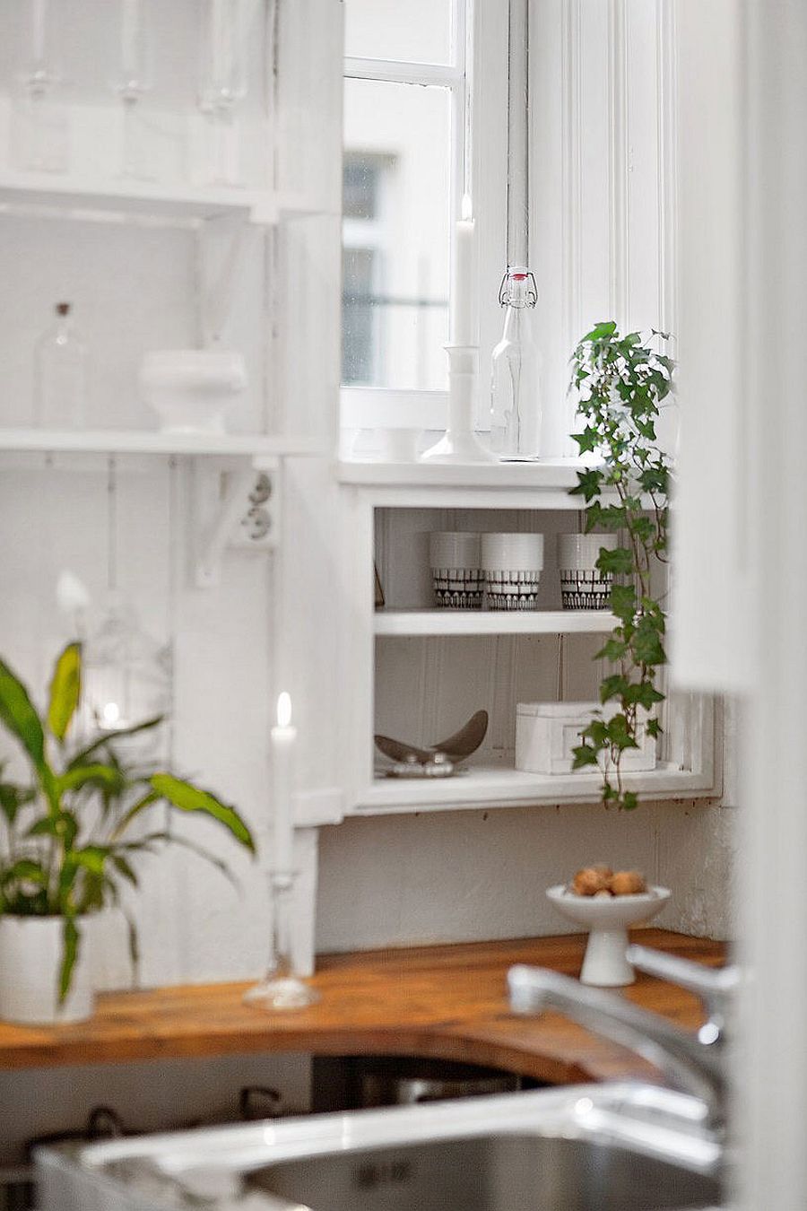 Open shelves in the tiny kitchen with small workstation