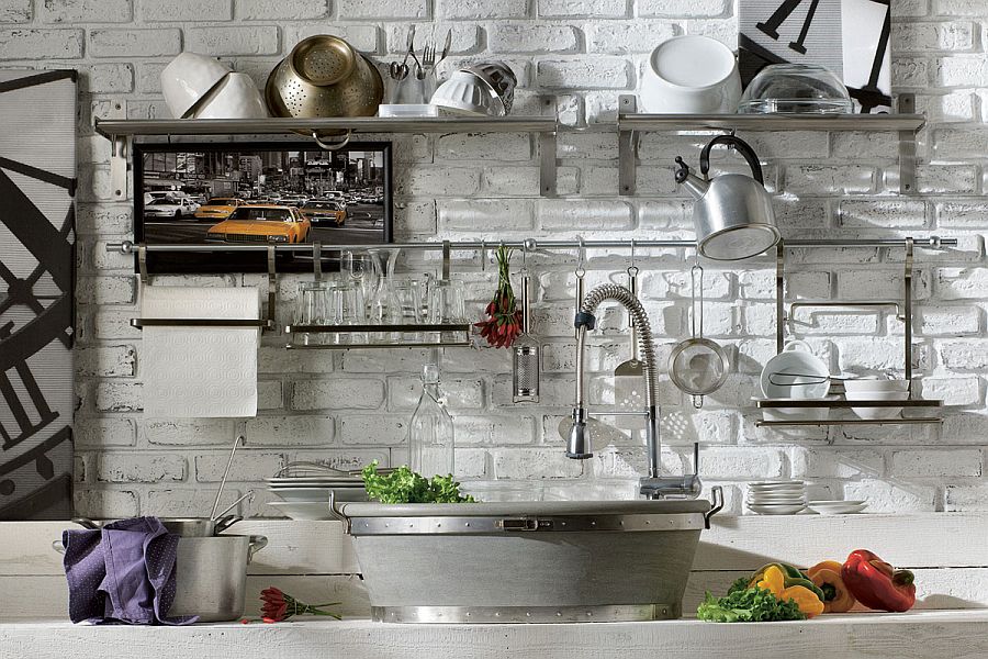 Open stainless steel shelves set against brick wall in the kitchen