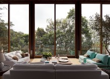 Outdoor-sitting-area-in-a-glass-enclosure-with-a-view-of-the-forest-and-the-ocean-217x155