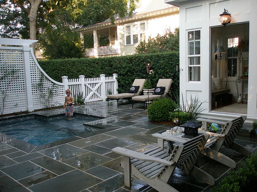 Tiny backyard pool surrounded by pavers and seating.