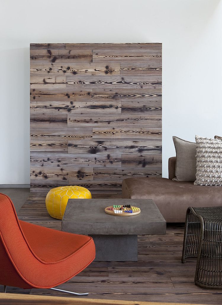 Reclaimed wood shapes a lovely feature wall in the living room [Design: DuChateau Floors]