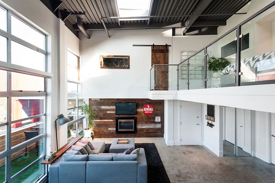 Reclaimed wood shapes the feature wall in the living room of the vancouver loft