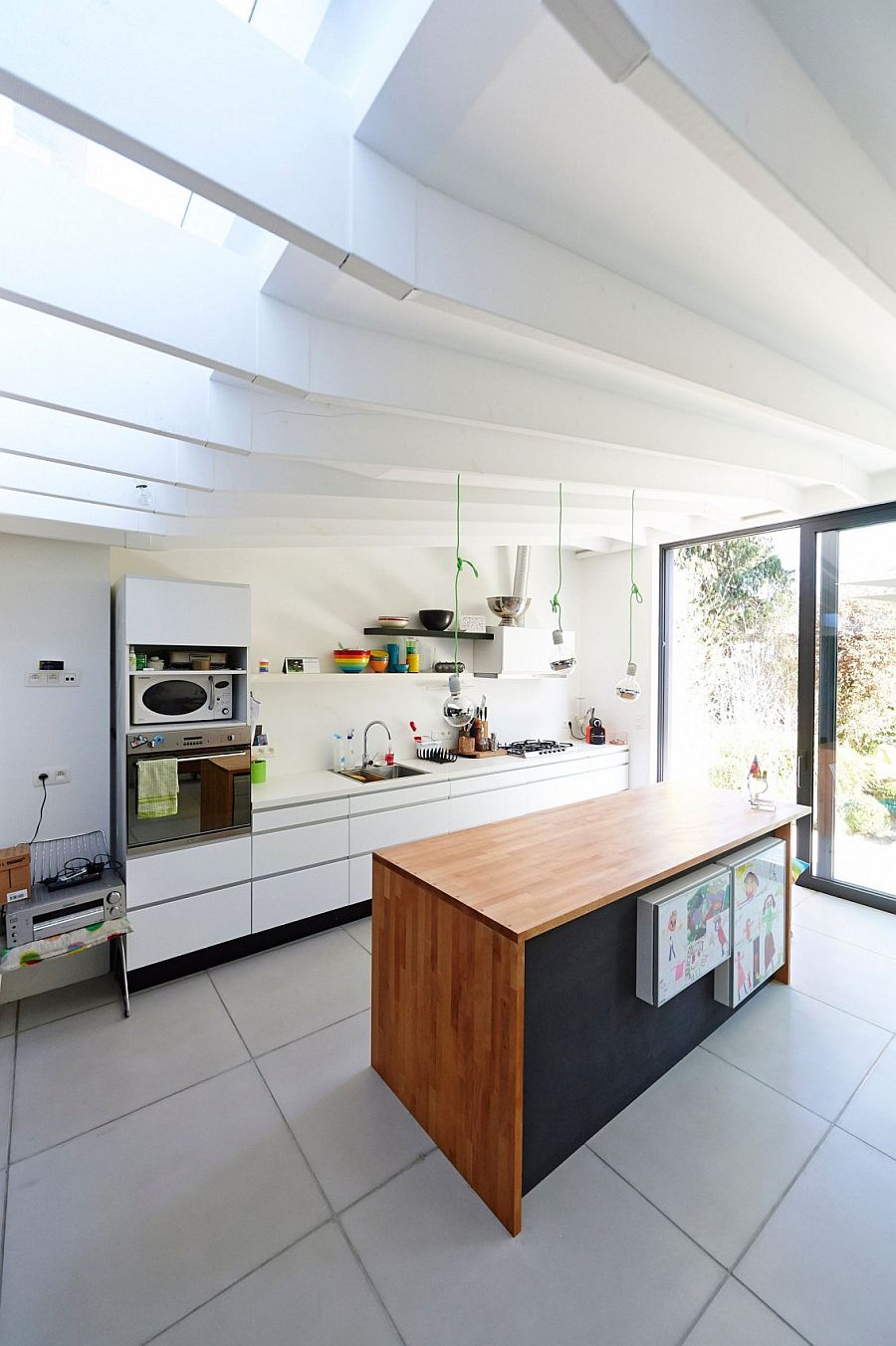 Sleek kitchen workstation in white and wooden island