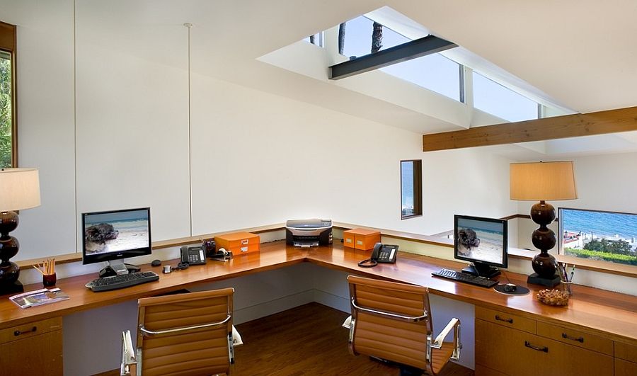 Small home office with slanted roof and skylight