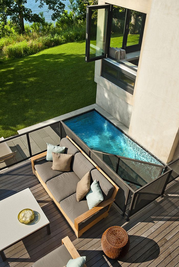 A small modern pool integrated into the deck of a modern house.