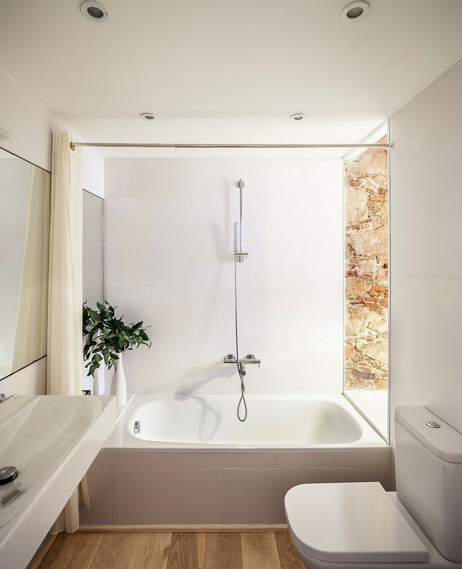 Smart, small bathroom design combines natural stone with all-white modern surfaces