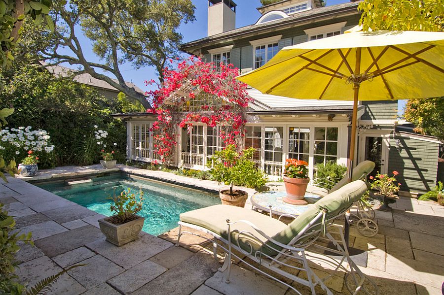 A home's backyard with yellow umbrella. 