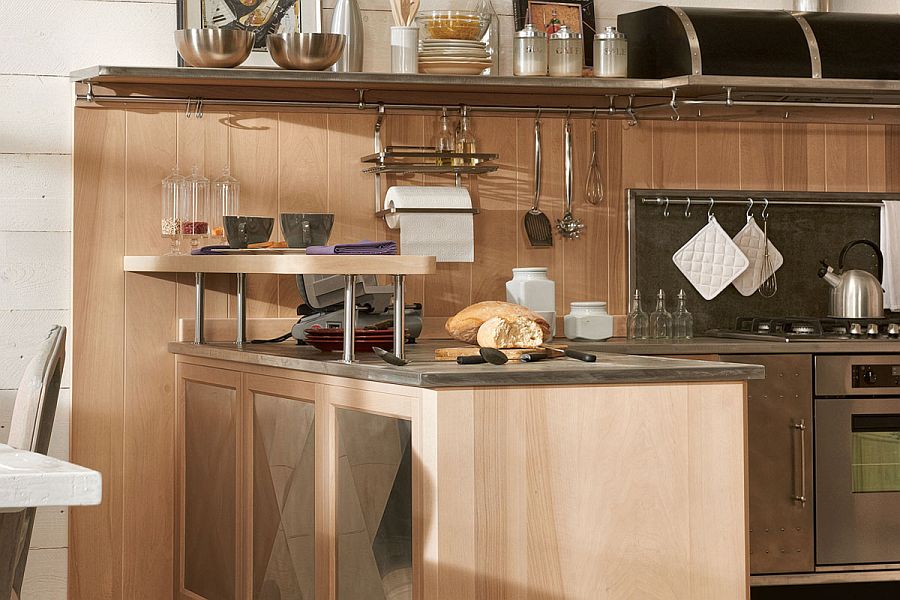 Steel worktop and wooden cabinets shape the kitchen workstation