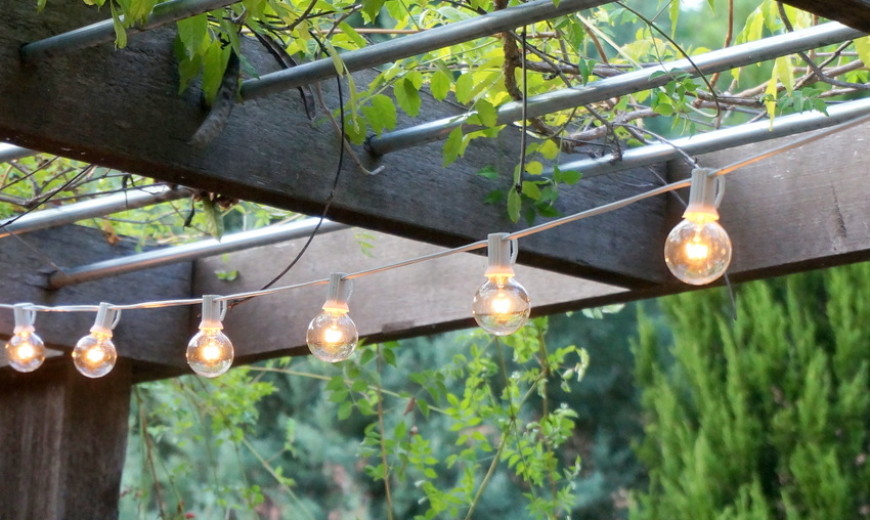 String lights hang from an overhead trellis