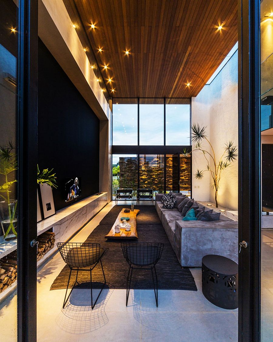 Stunning living area with high ceiling and glass walls