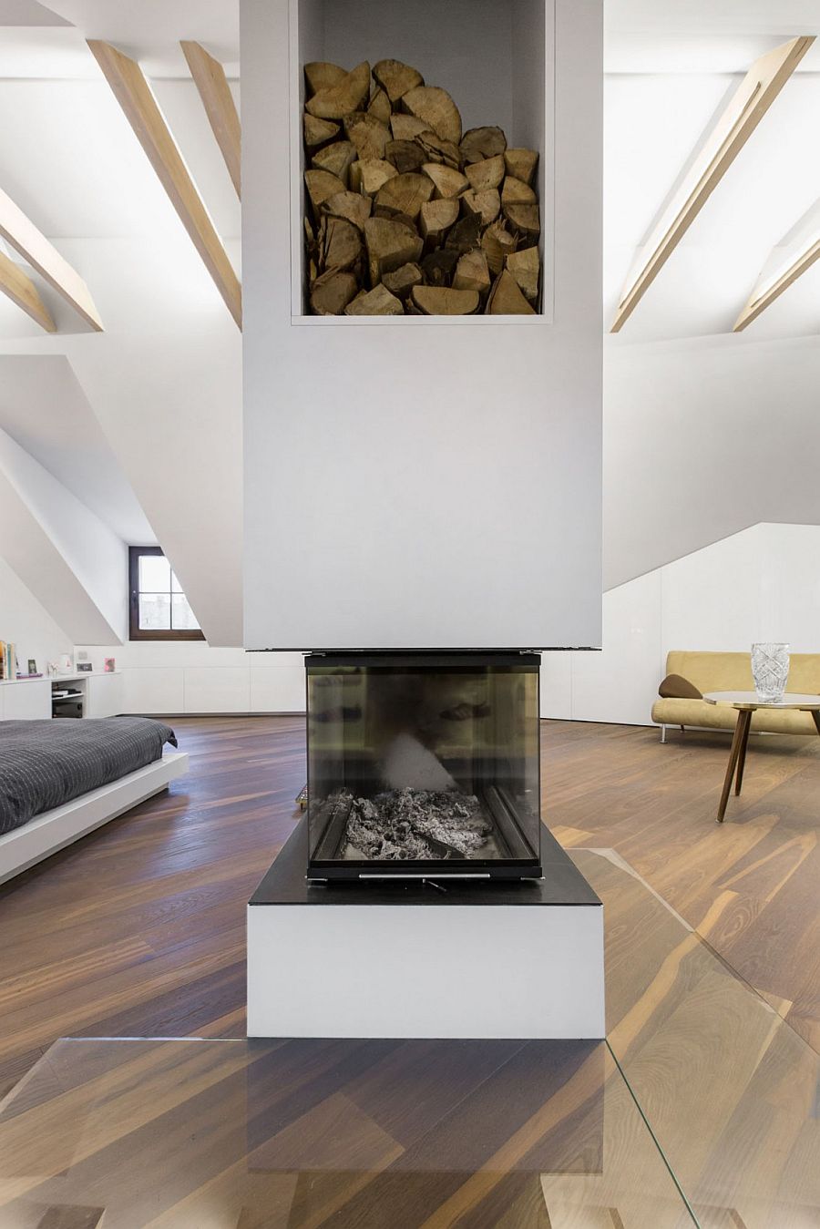 Two-sided fireplace serves the living area and the bedroom