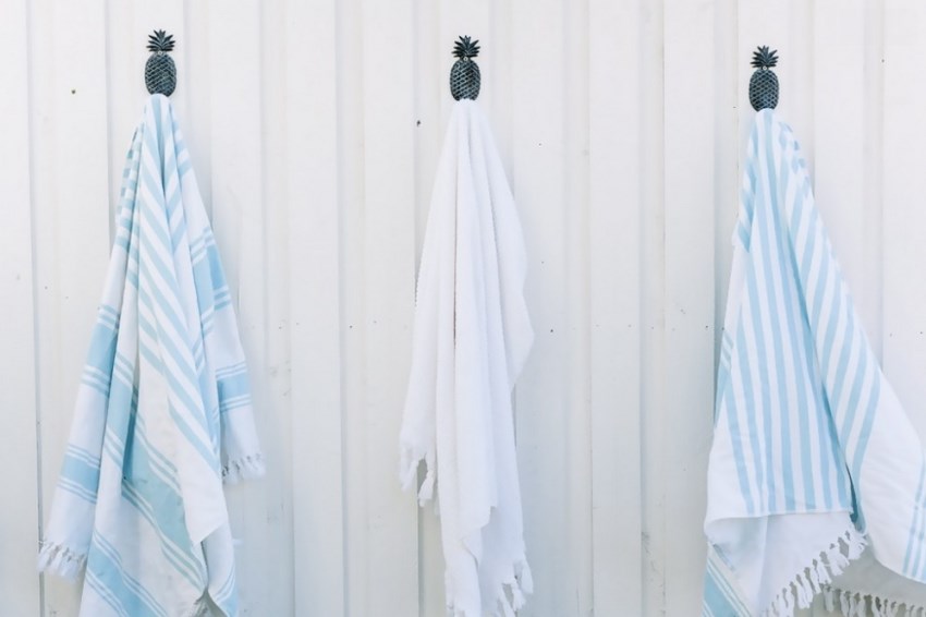 Beach towels on pineapple hooks