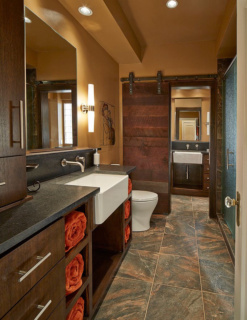 Beautiful bathroom barn door crafted from reclaimed Black Walnut lumber [Design: USI Design & Remodeling]