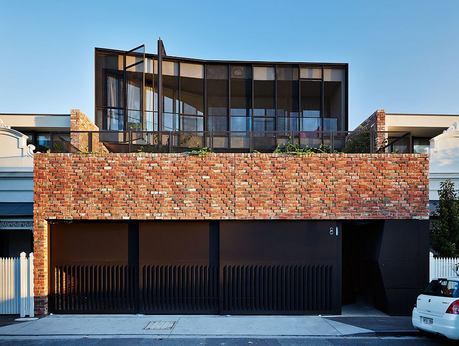 Brick and steel exterior of the warehouse-styled home with a creative entry