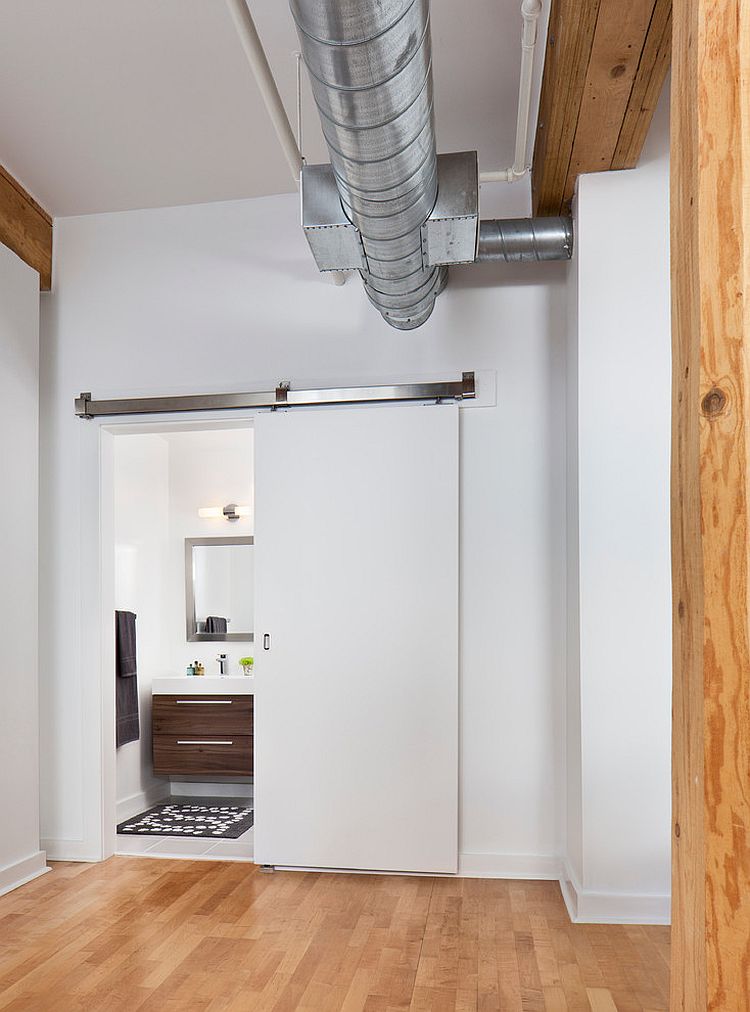 Contemporary barn door in white for the industrial bathroom