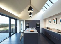 Contemporary-kitchen-design-with-large-windows-skylights-and-black-pendant-lights-217x155