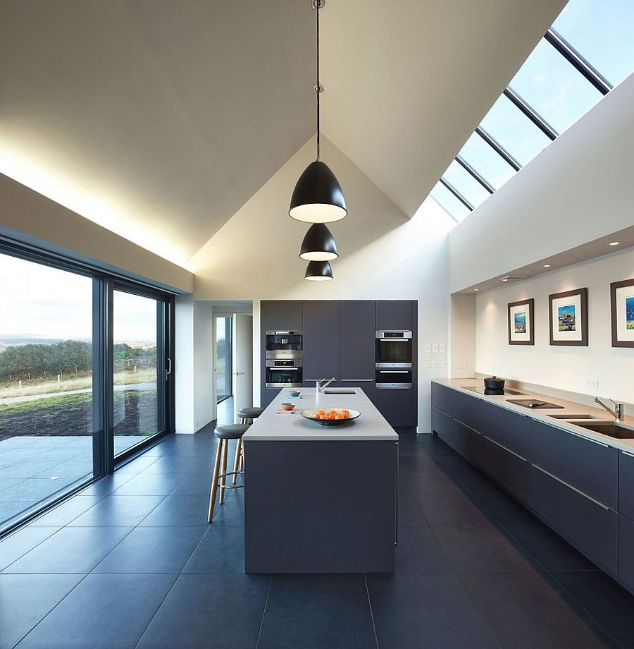 Contemporary kitchen design with large windows, skylights and black pendant lights