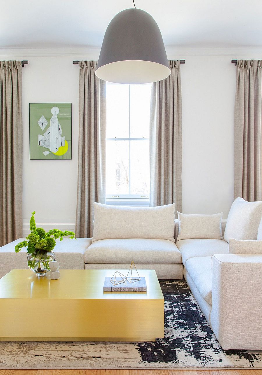 Custom brass coffee table and oversized pendant in the Chelsea apartment living room