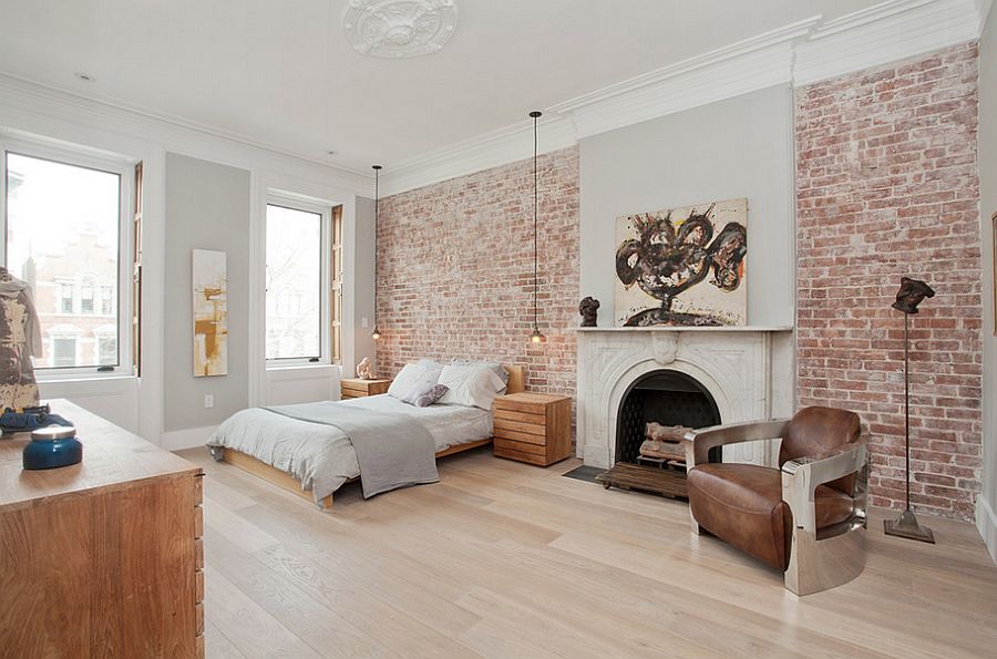 Exposed brick wall brings textural beauty to the posh bedroom