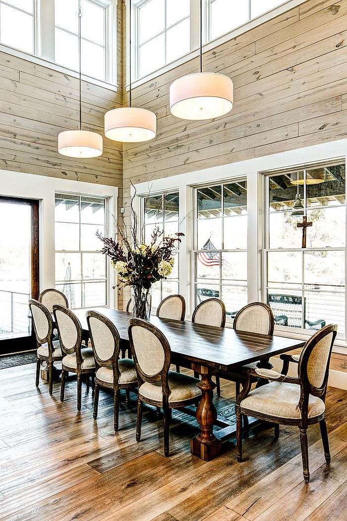 Farmhouse style dining room with high ceiling and glass windows