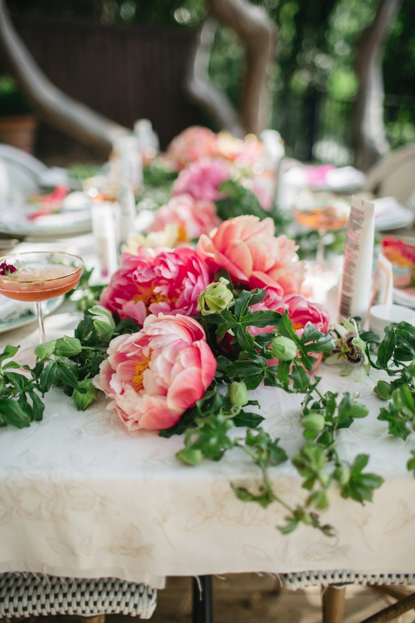 Floral table runner at an outdoor garden party