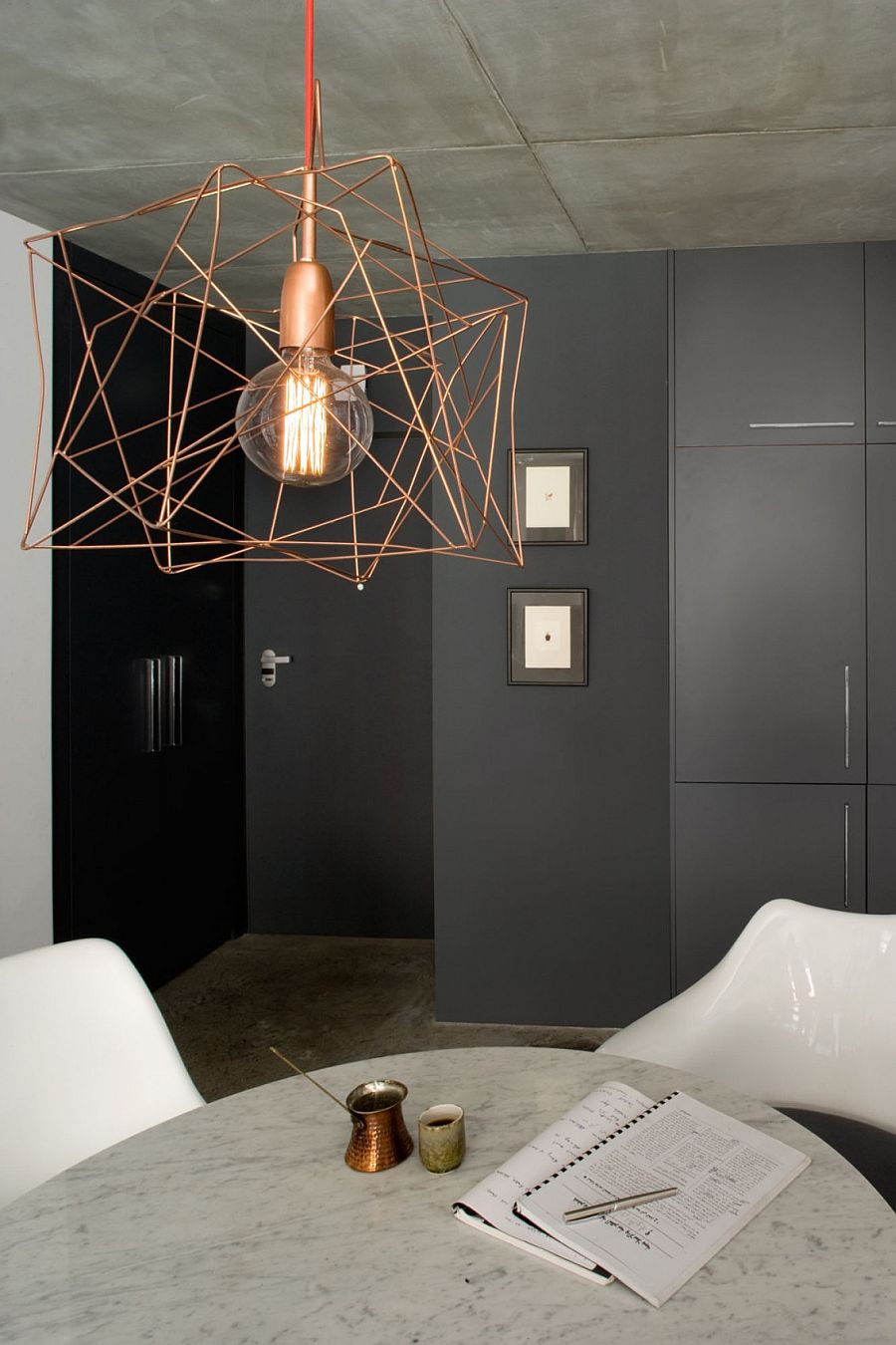 Gray backdrop and snazzy lighting add to the appeal of the quirky, small apartment