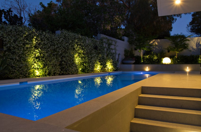 Illuminated pool area with a spherical outdoor lamp