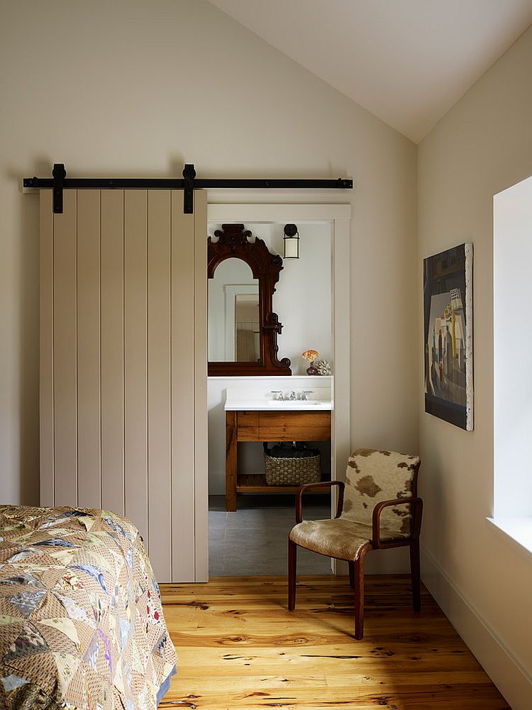 Lovely farmhouse style bathroom with a sliding barn door [Design: Moger Mehrhof Architects]