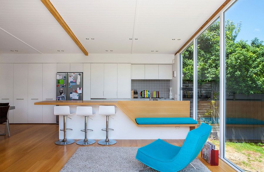 Lovely modern kitchen in white with wooden accents and glass walls