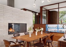 Modern-dining-room-with-fireplace-and-large-glass-walls-217x155