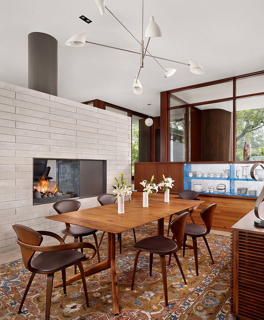 Modern dining room with fireplace and large glass walls