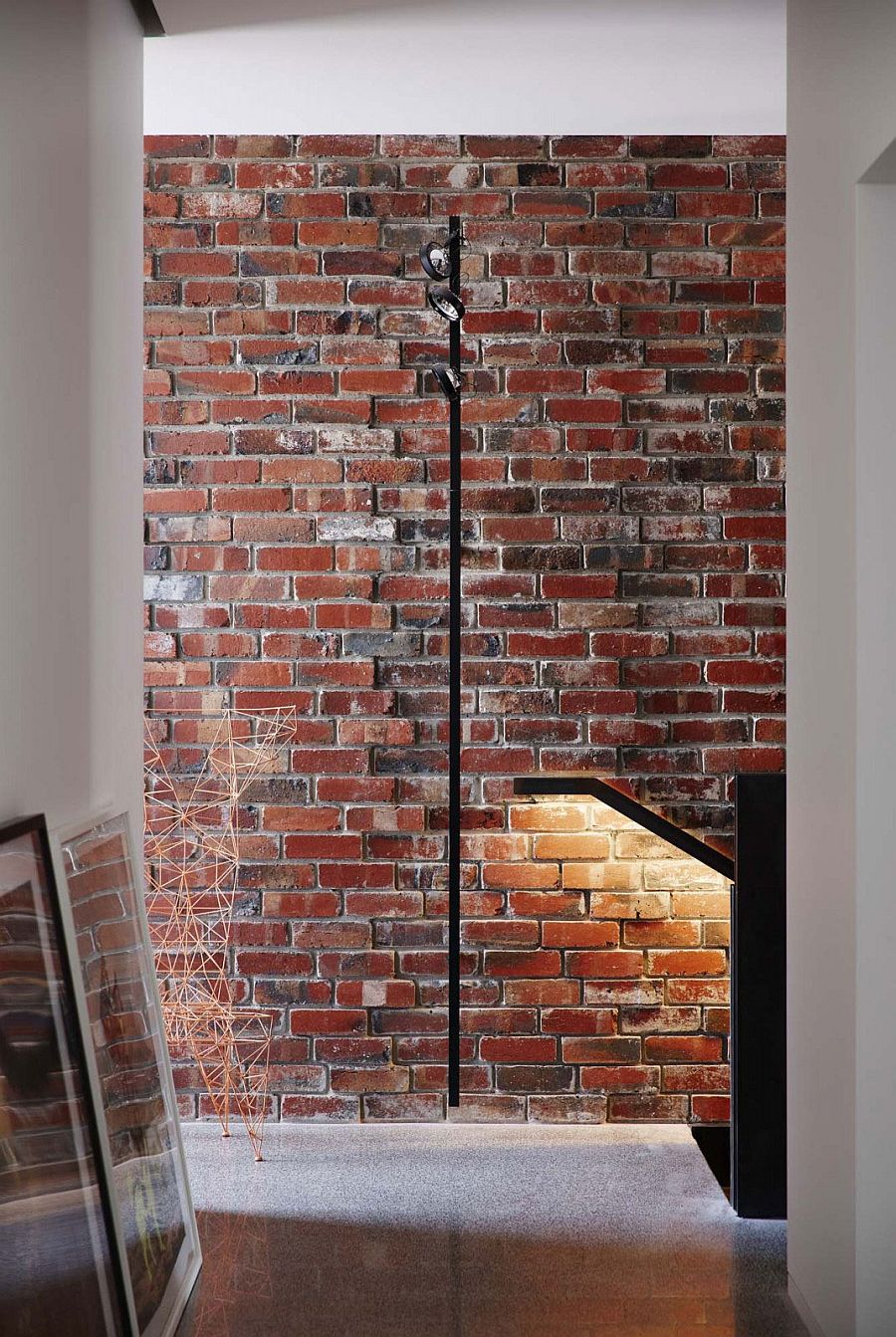 Original brick wall of the house exposed to give it a loft-like appeal