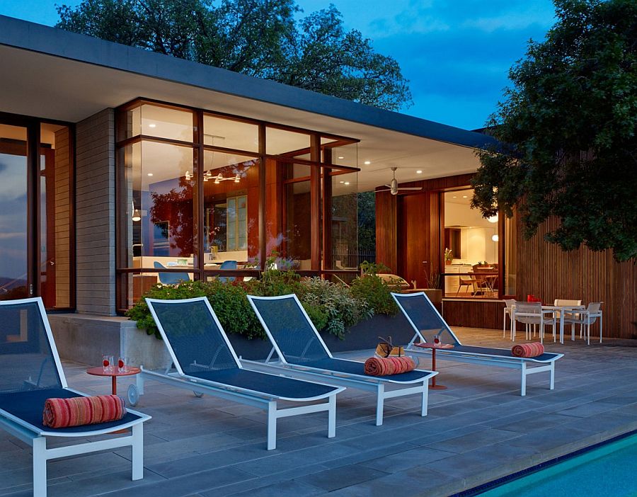 Poolside loungers in blue add color to the setting