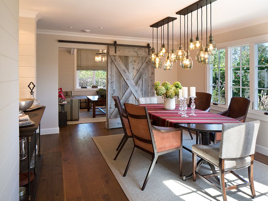 Sliding barn door and brilliant lighting steal the show in this dining room [Design: Anne Sneed Architectural Interiors]