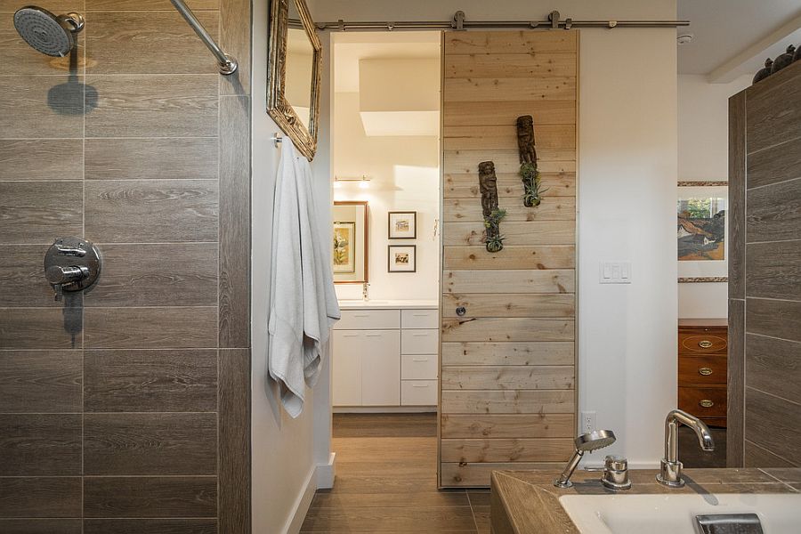 Sliding barn door saves up space in the small contemporary bathroom