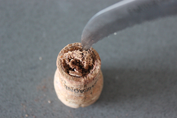 Start hollowing out wine cork with knife