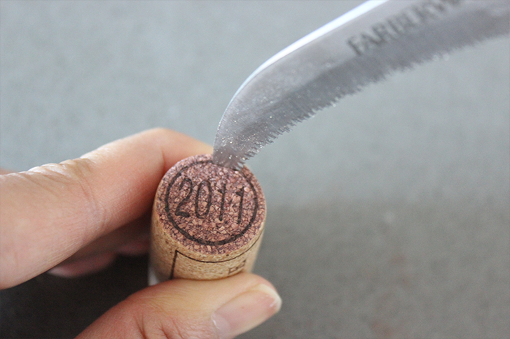Trace around circle at the top of wine cork with knife