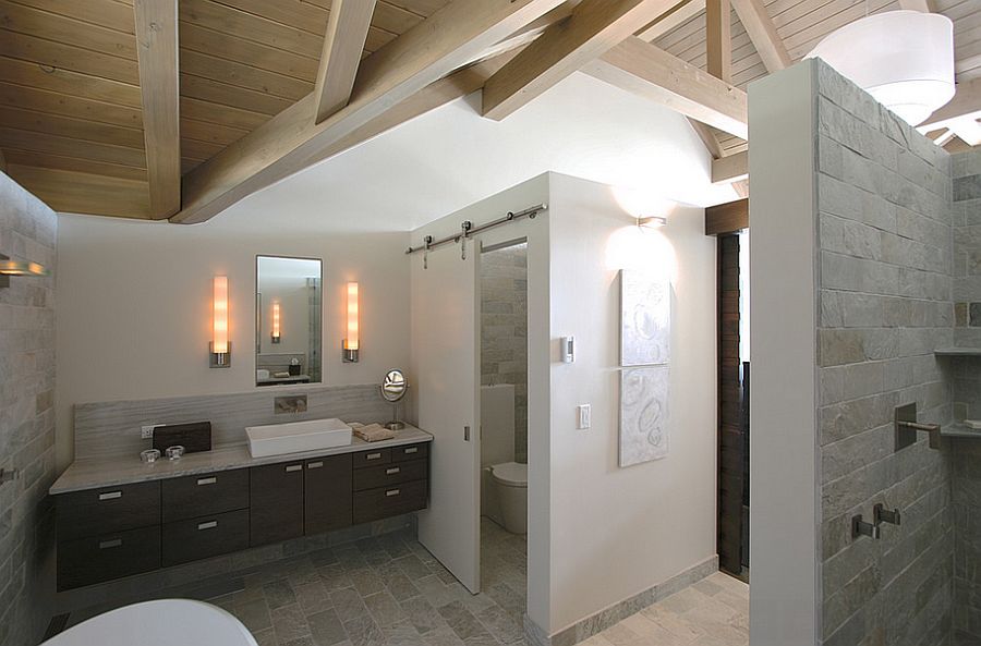 Using the sliding barn door for the toilet closet in the master bathroom [Design: Masterson Studio]