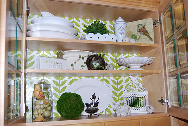 Using wrapping paper to spruce up the inside of kitchen cabinets