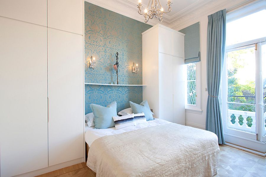 Wallpaper adds to the blue and white color palette of the bedroom