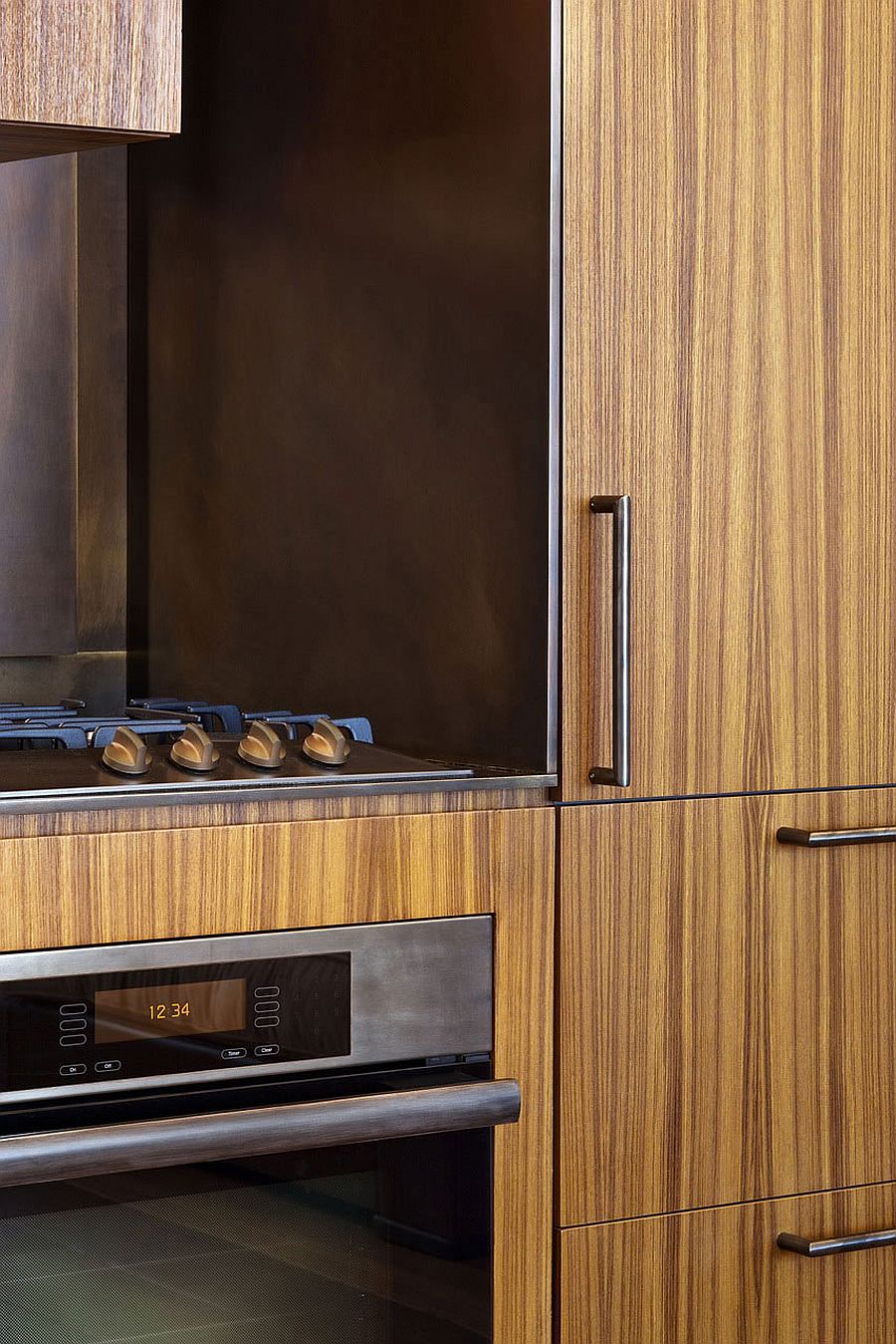 Wooden shelves and a sleek kitchen workstation bring elegance to the chic apartment