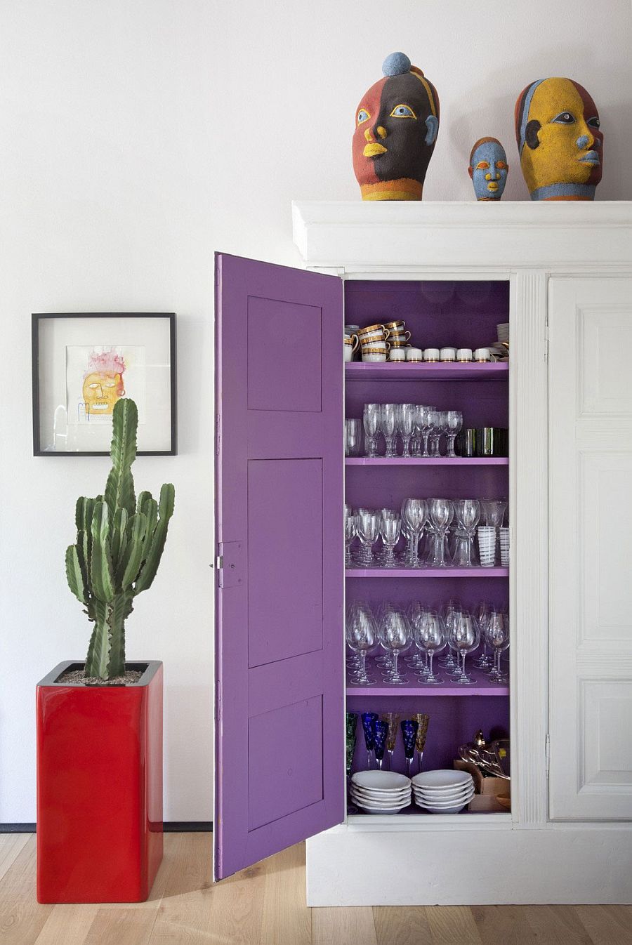 A touch of purpe charm on the inside of the dining room wall cabinet