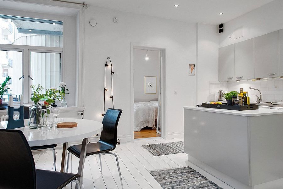 All-white kitchen and dining area of the Scandinavian home