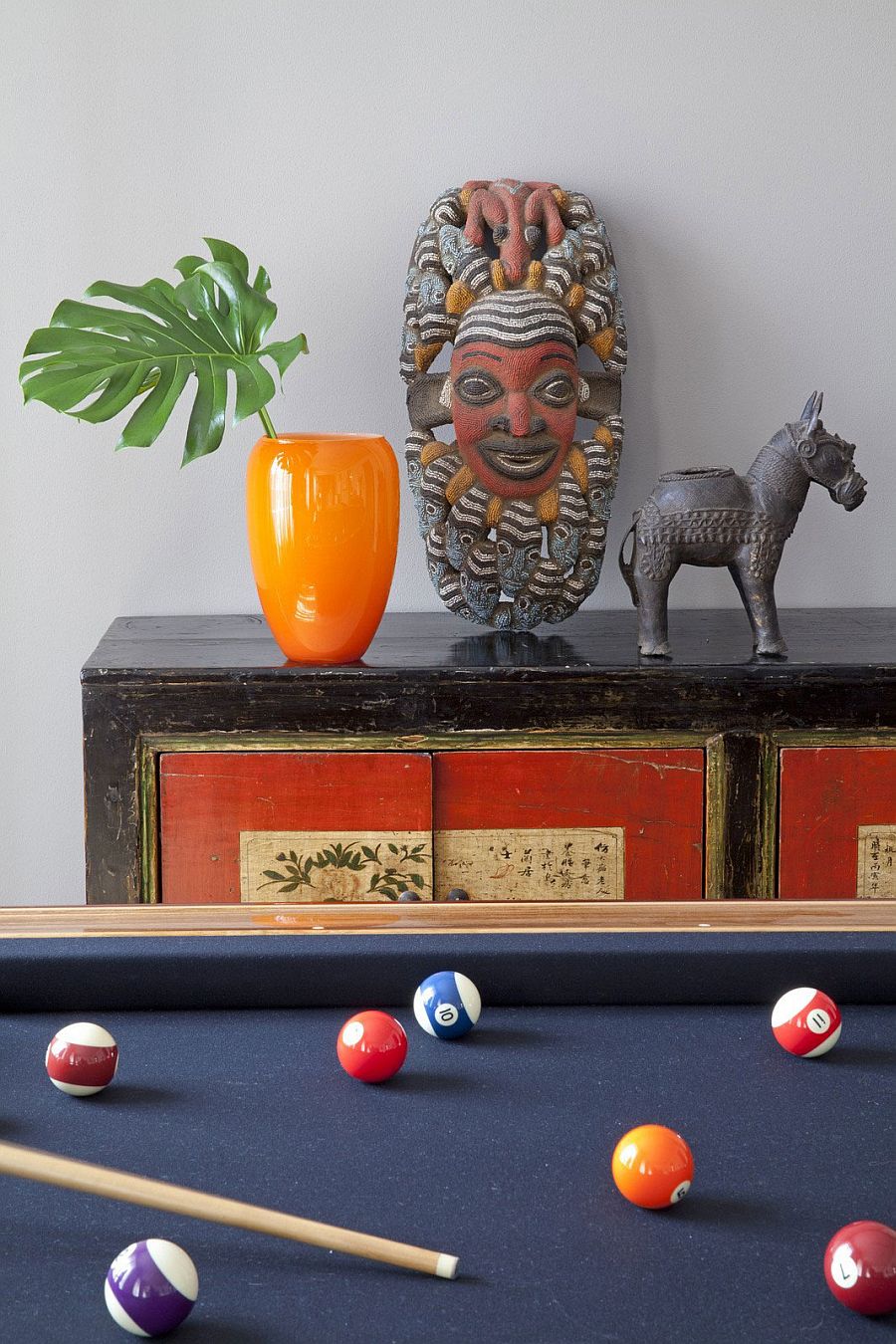 Antique cabinet next to the pool table in the family room