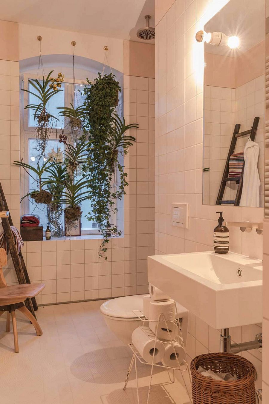 Bathroom in white filled with hanging plants