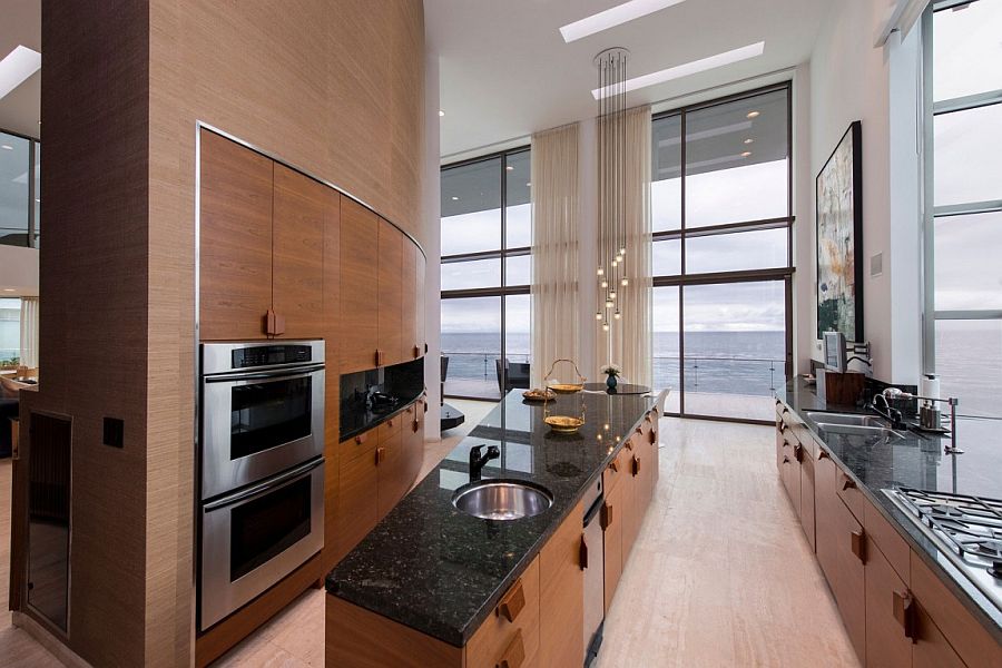 Cascading chandelier adds radiant beuaty to this expansive kitchen