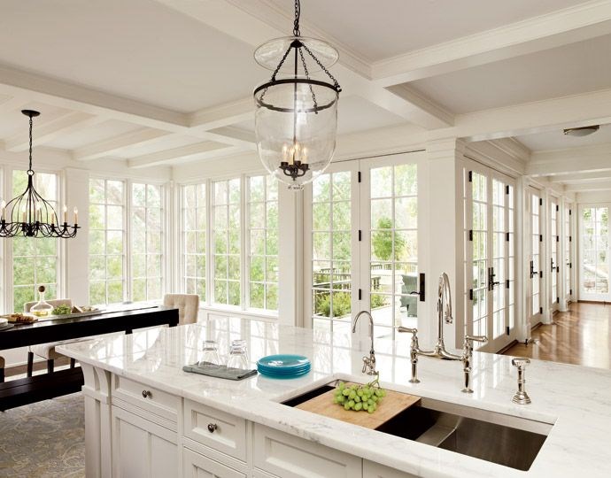 Coffered ceiling in a bright kitchen with marble countertops