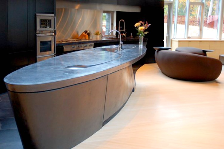 An unusually shaped countertop is complimented by the furniture choices