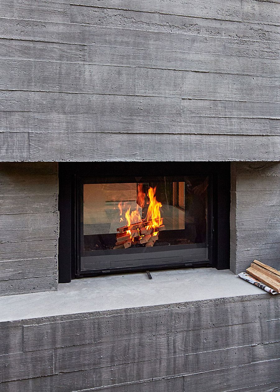 Concrete exterior of the modern home with a smart fireplace