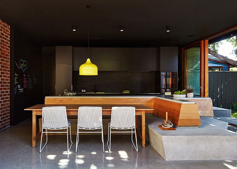 Dark kitchen backdrop lets the bright yellow pendant shine through